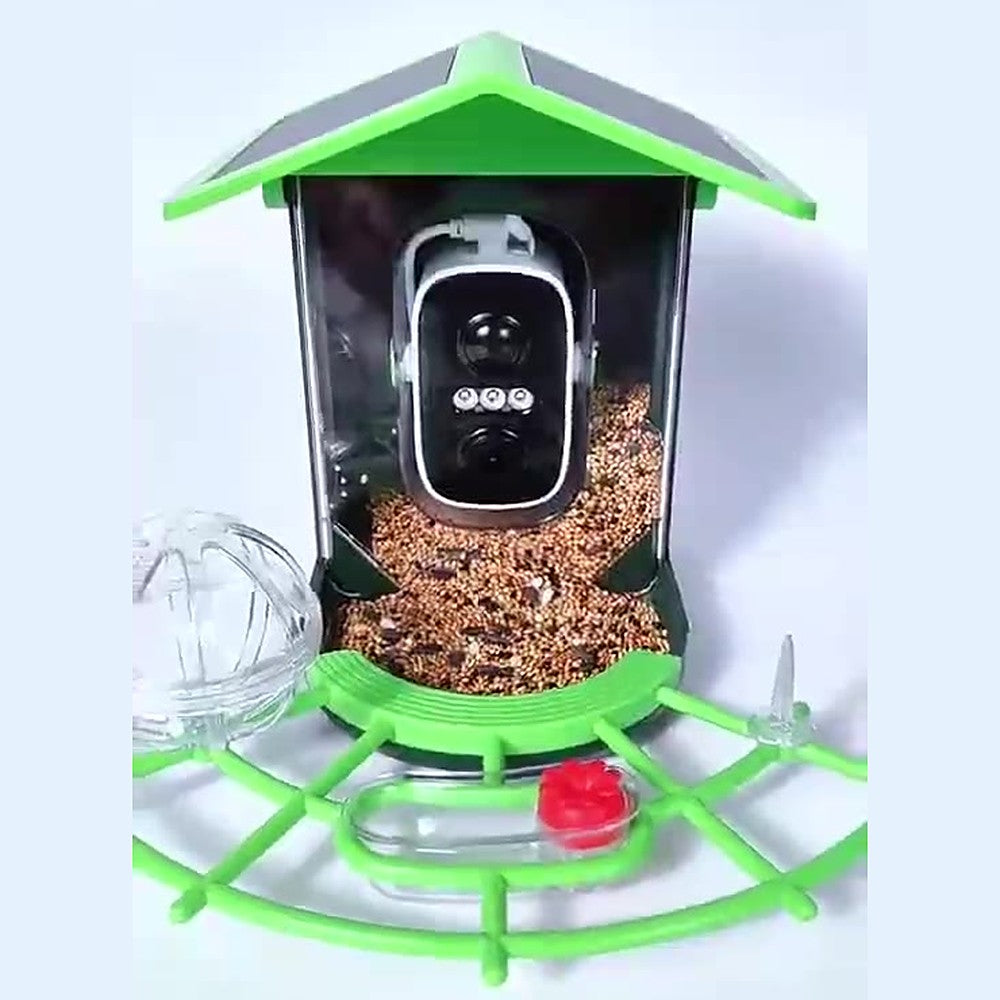 Front view of Fuglekikk with seed, perch, water cup, fruit ball and fruit skewer